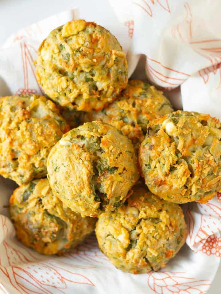 A napkin lined basket of feta spinach muffins.