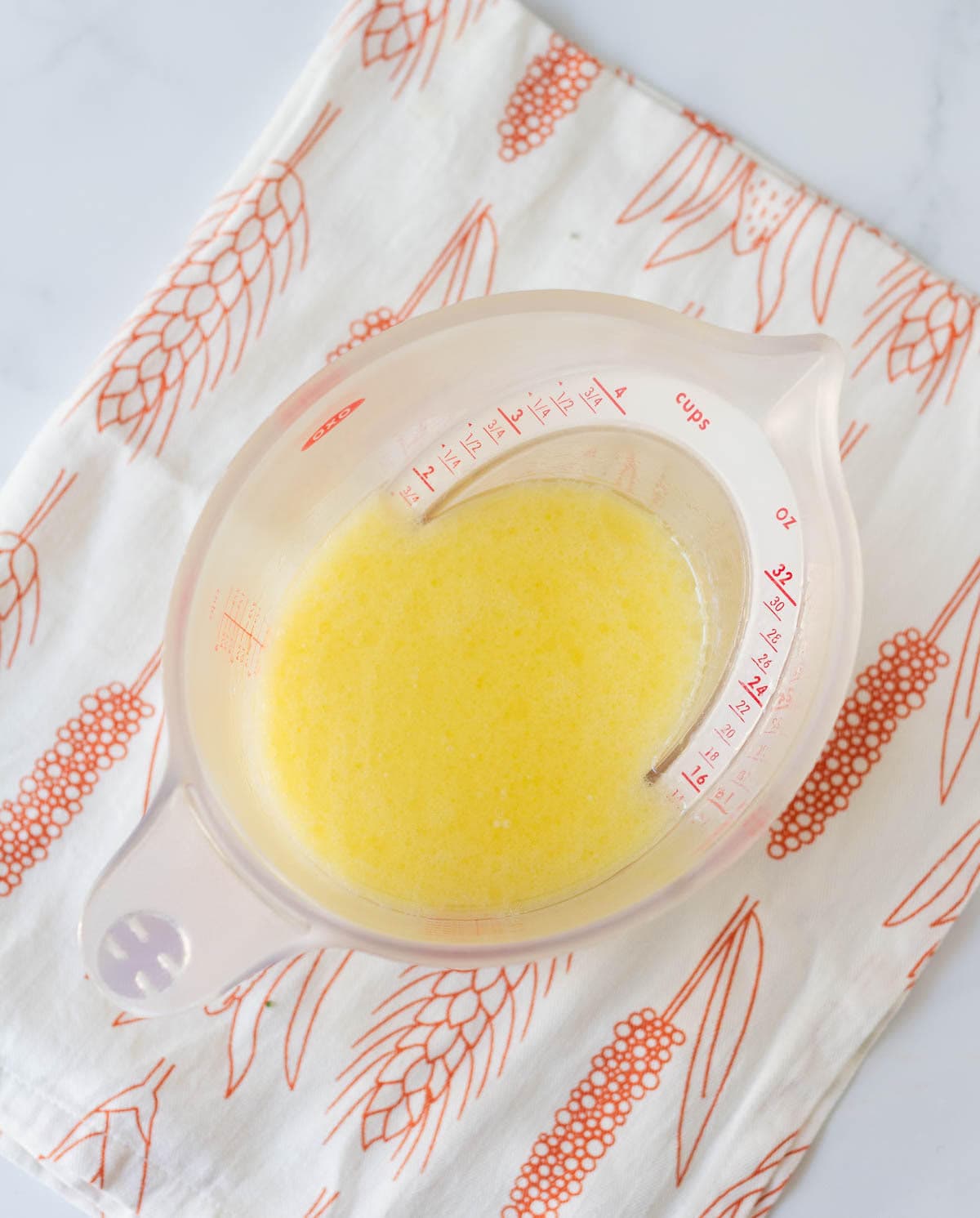 Mixture of egg, milk, oil in a measuring cup.