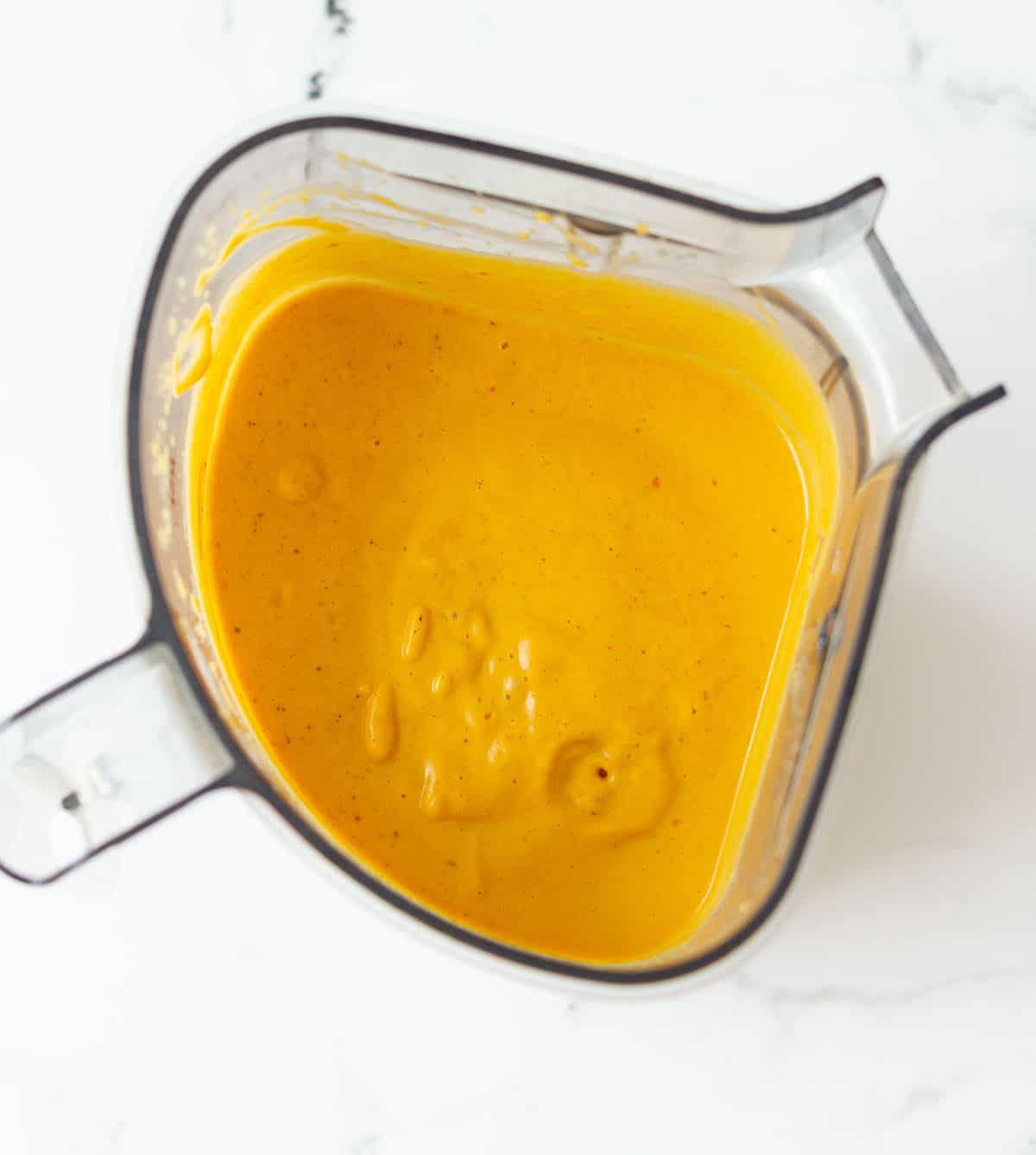 Blended pumpkin sauce in a blender jar.