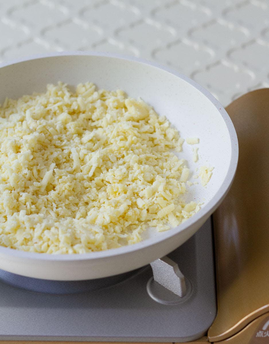 grated khoya and ghee in a pan