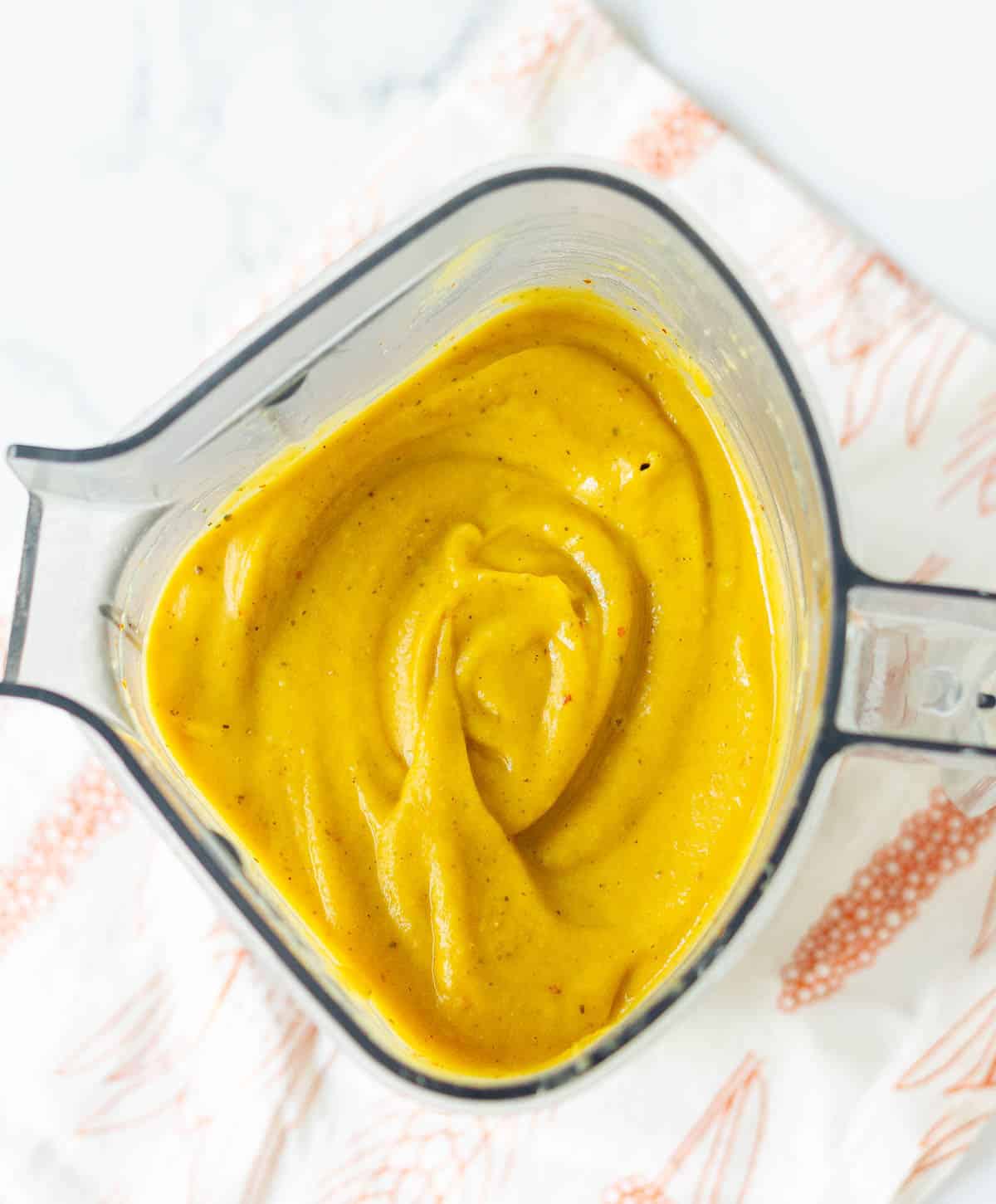 blended creamy roasted sweet potato soup in a blender jar.