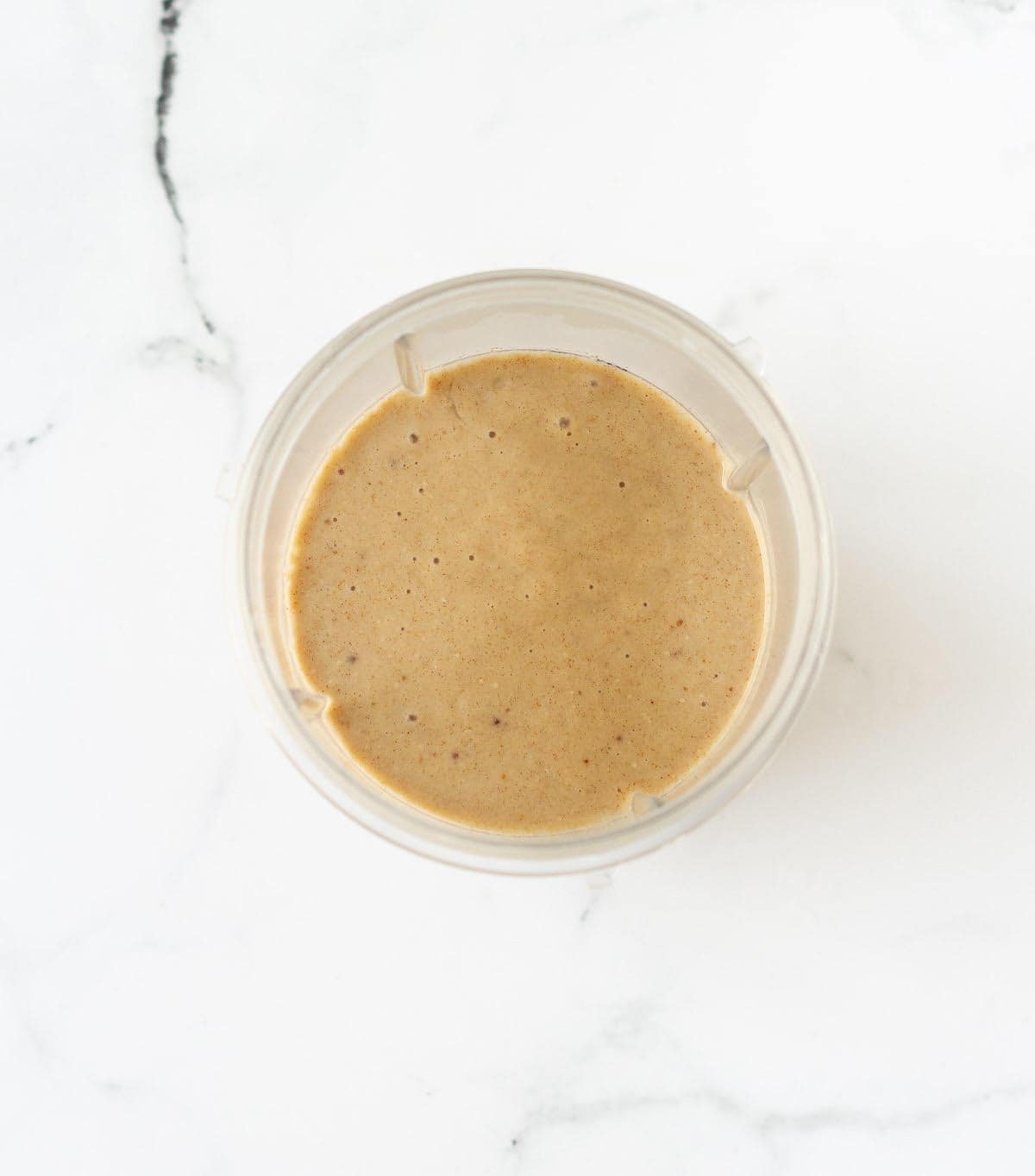 blended ingredients for fig smoothie in a blender jar.