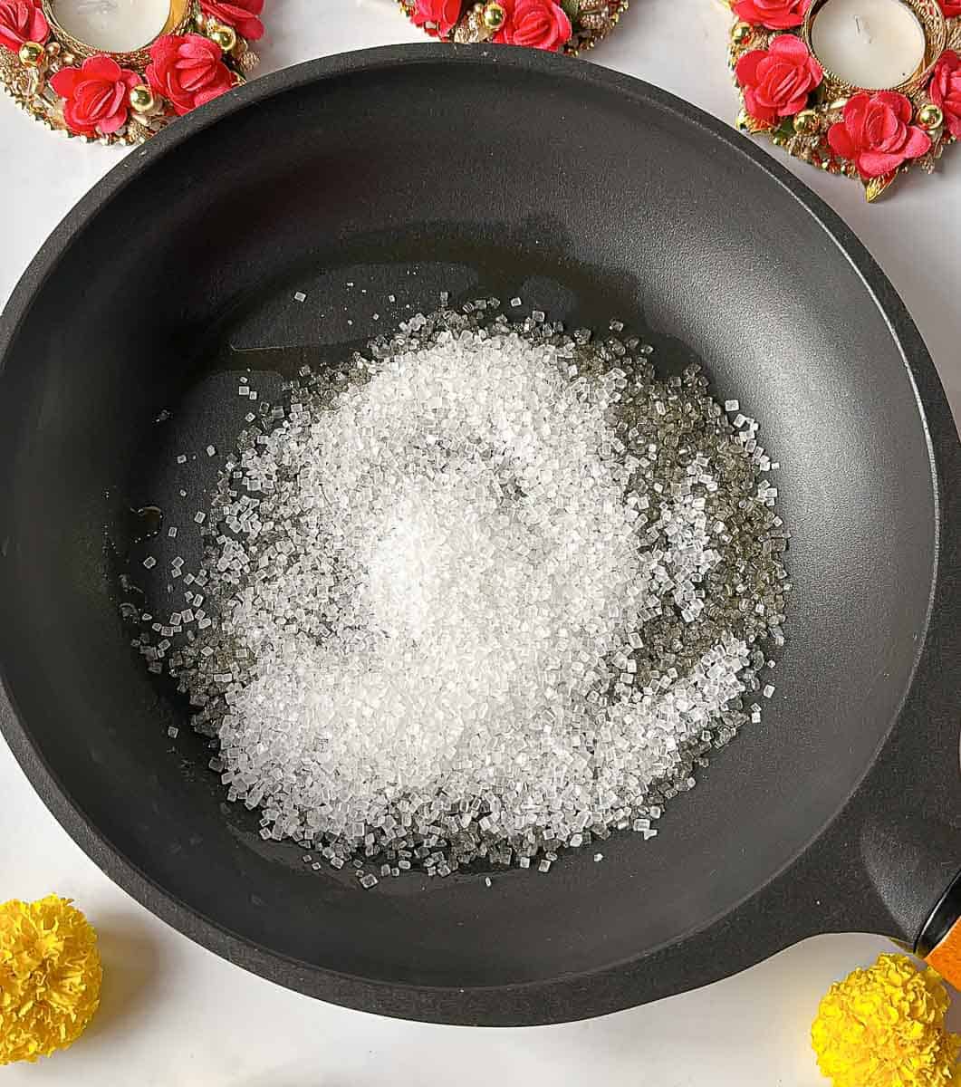 Add sugar to the  pan
