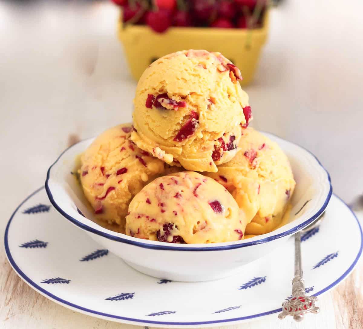 Scoops of mango frozen yogurt in a bowl.