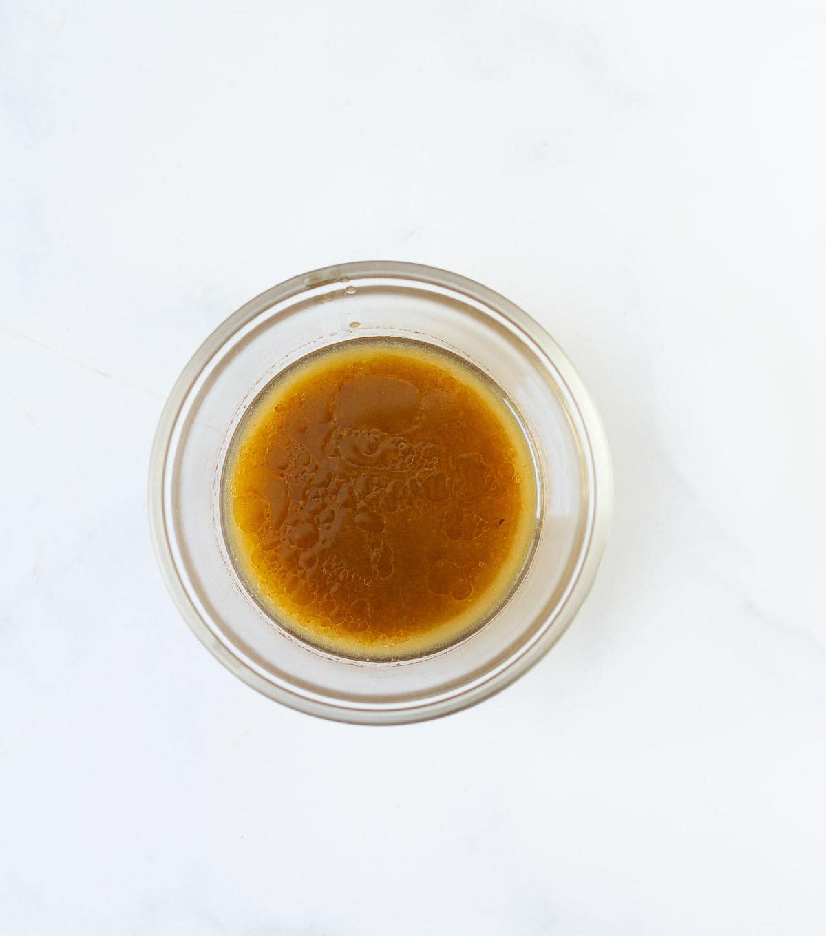 Salad dressing in a small bowl.