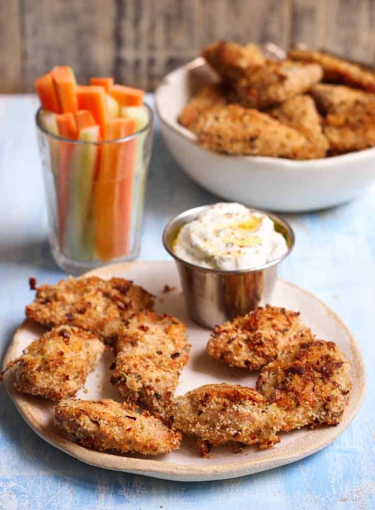 Crispy Baked Chicken Nuggets with a dip and veggies.