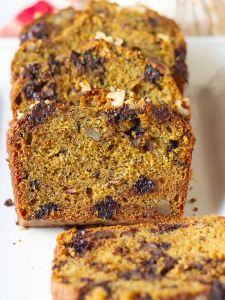 Sliced pumpkin banana bread on a white platter.