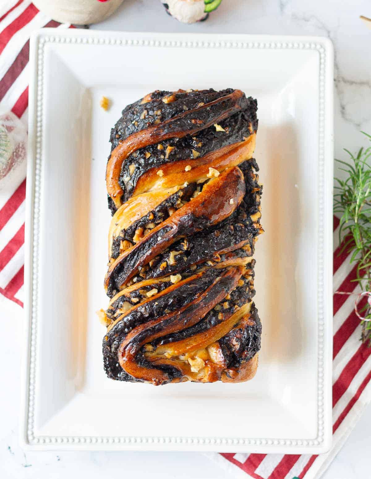 loaf of babka on a white serving platter.