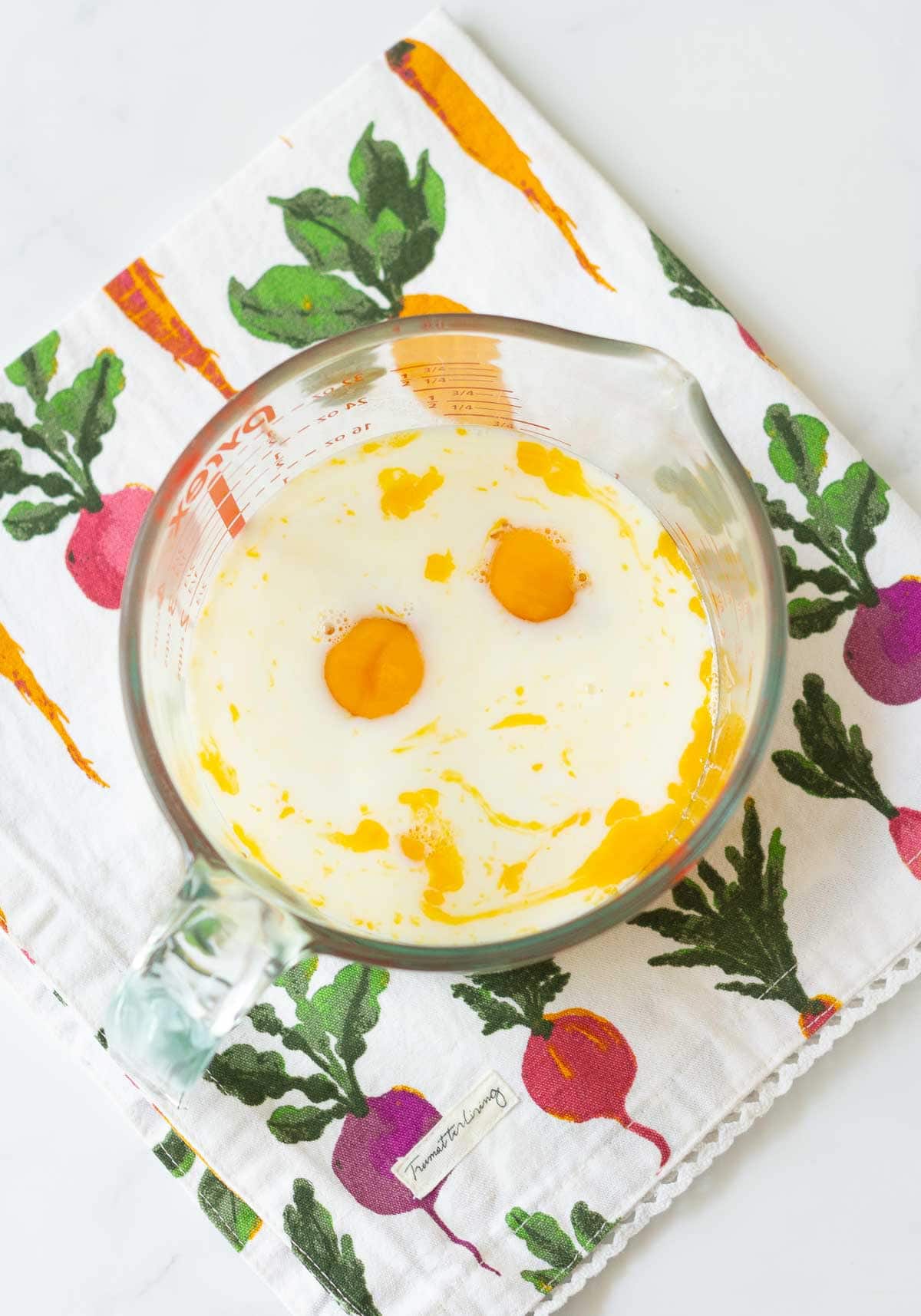 Eggs, milk, sugar, and vanilla extract in a bowl.
