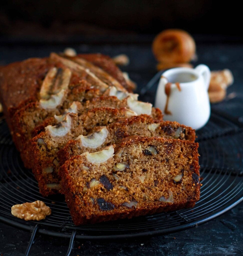 Sliced walnut & fig bread on a black trivet.