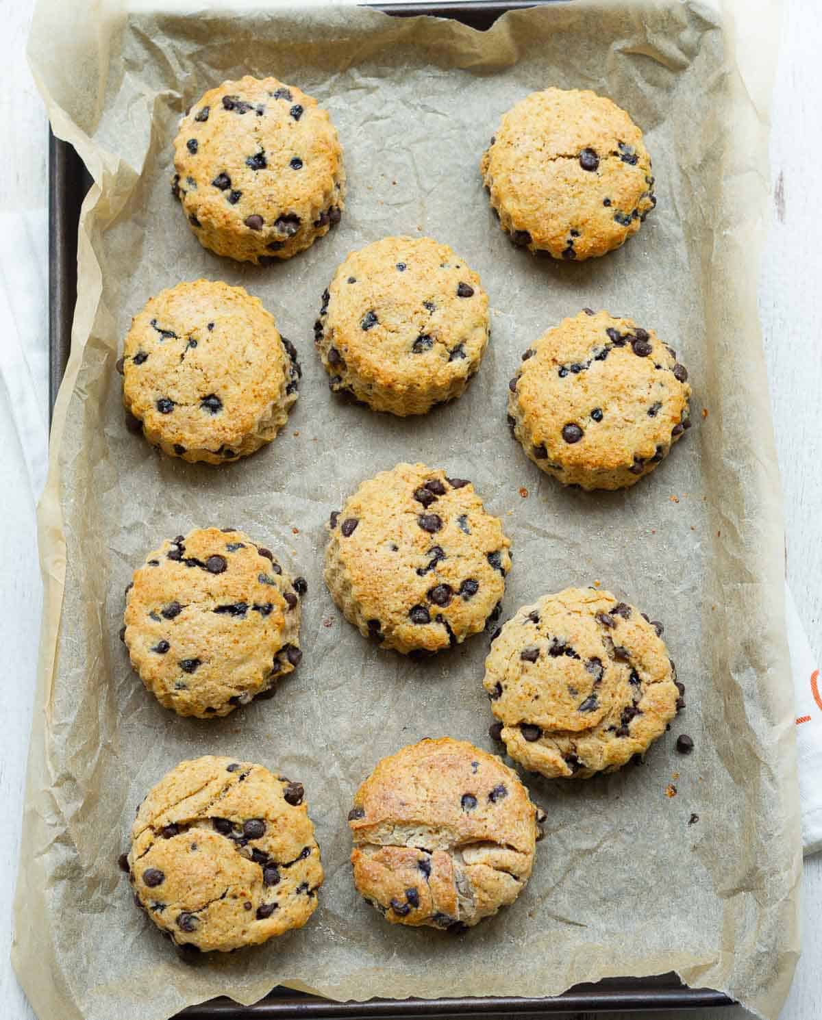 Baked cinnamon scones on parchment-lined baking tray.