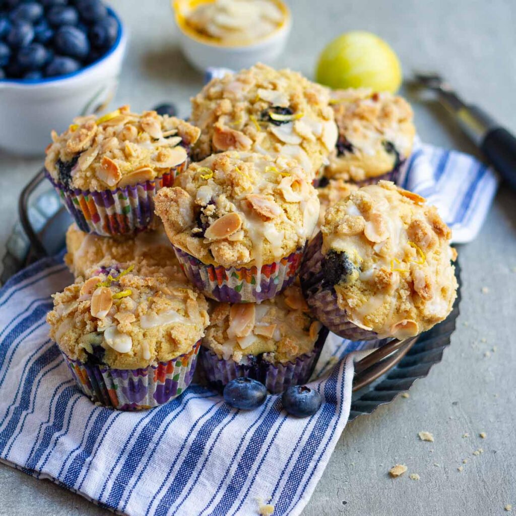 Blueberry Muffins on a blue striped napkin on a wire rack.