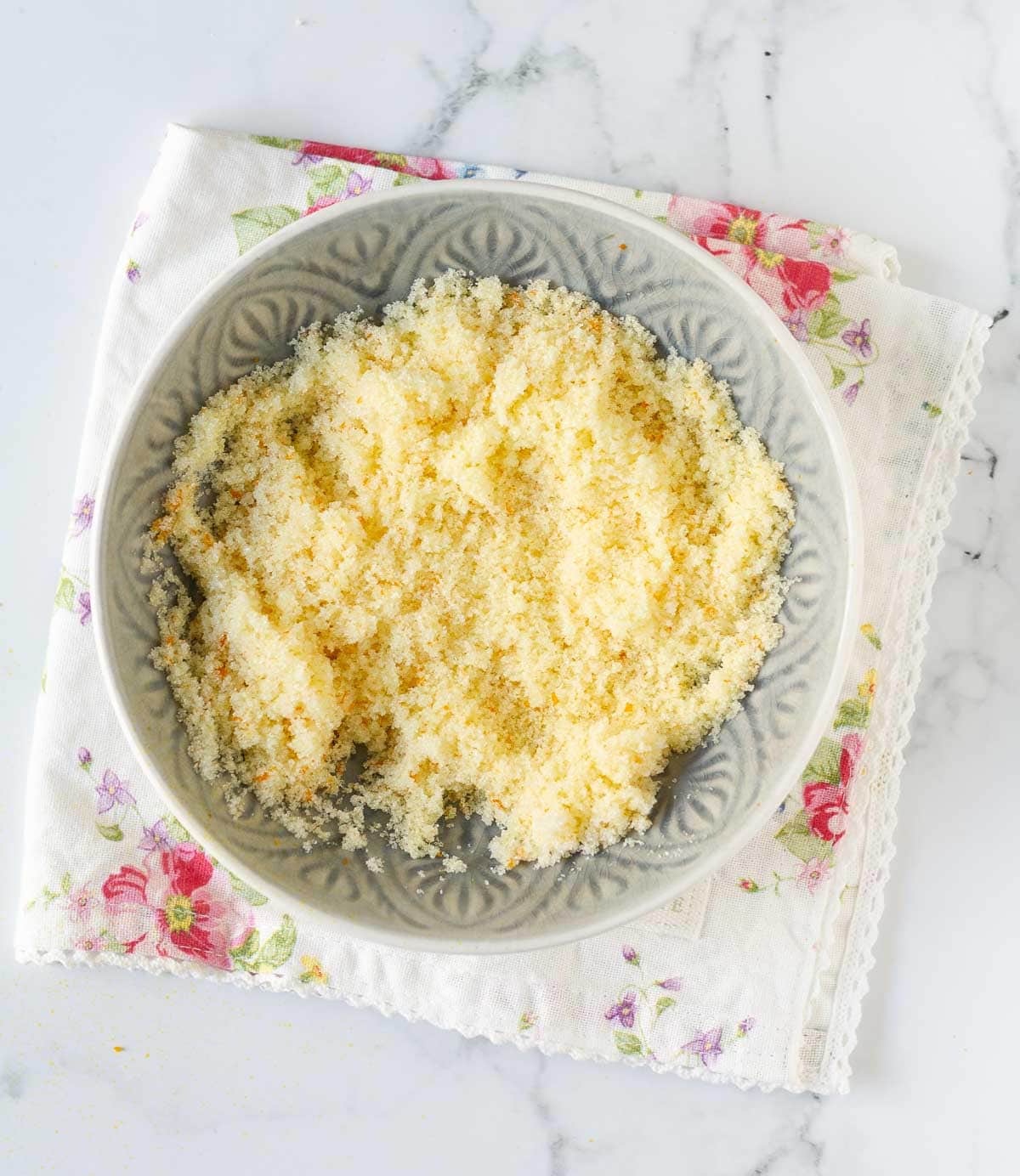 Sugar and orange zest mixture in a bowl.