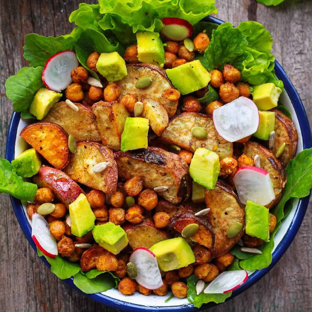 sweet potato and chickpea salad with veggies in a bowl.