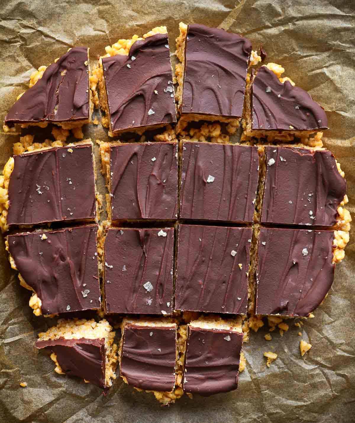 peanut butter Rice Krispie bars cut into pieces on parchment paper.