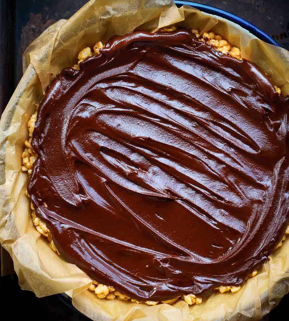 Chocolate mixture poured over the Rice Krispie base in a parchment-lined pan.