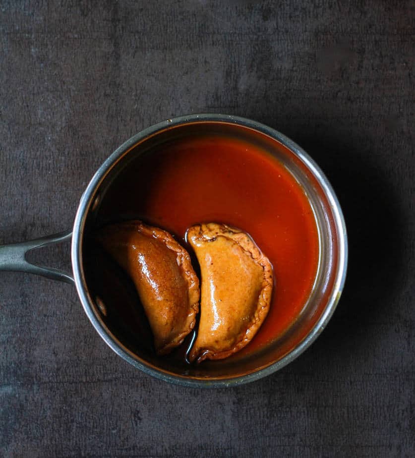Dipping the gujiyas in the jaggery syrup | Gujiya | Baked Mawa Gujiya