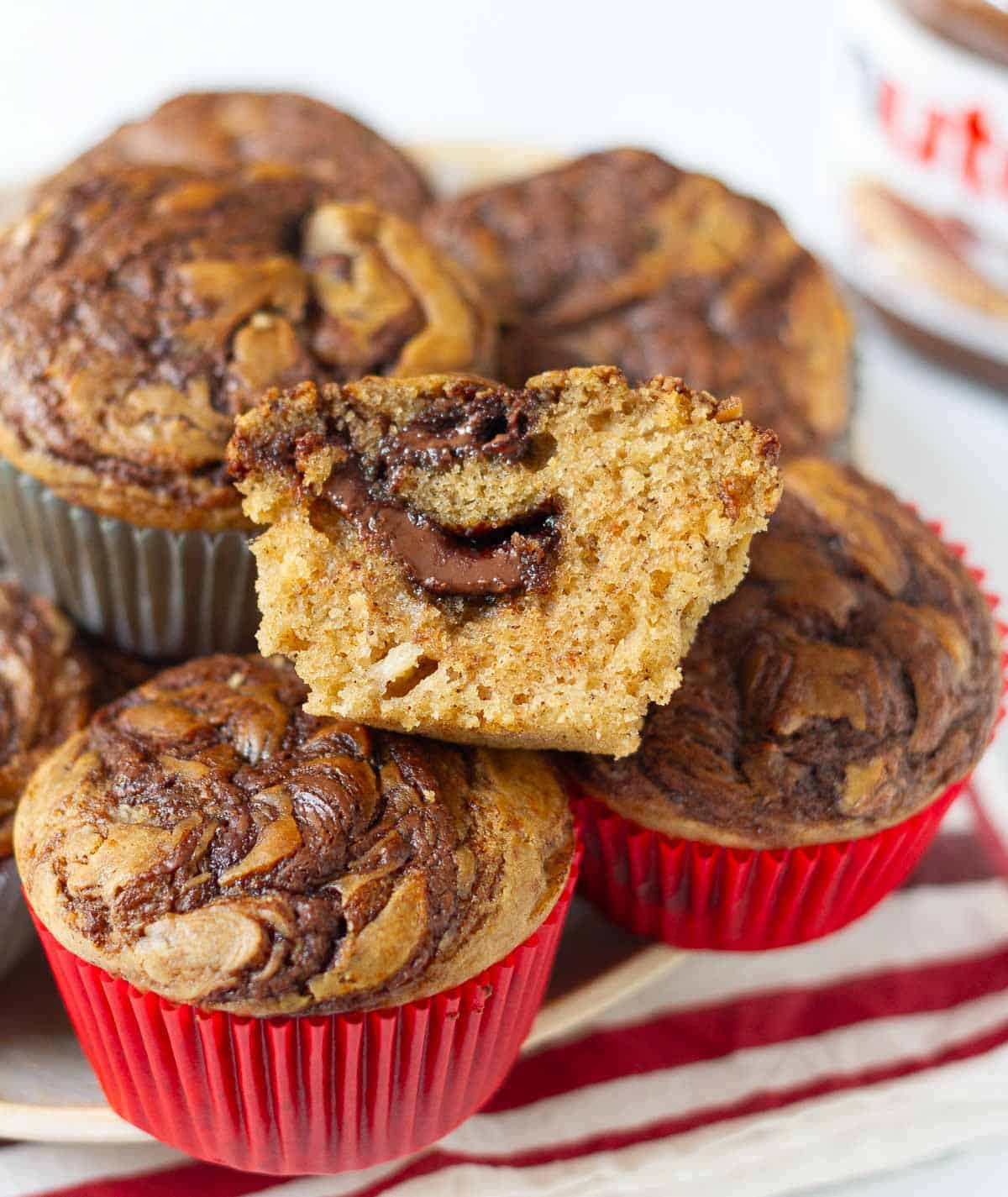 Half a muffin on top of a stack of muffins to show the cross section.