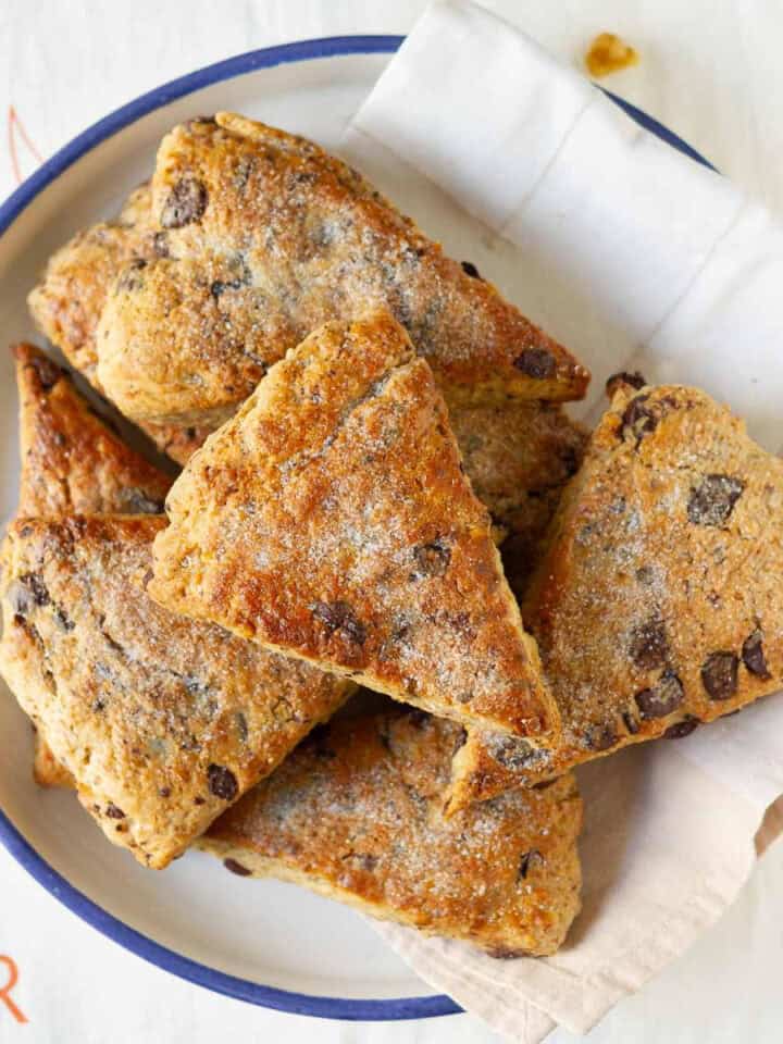 Banana scones with walnuts and chocolate chips in a bowl with a napkin.