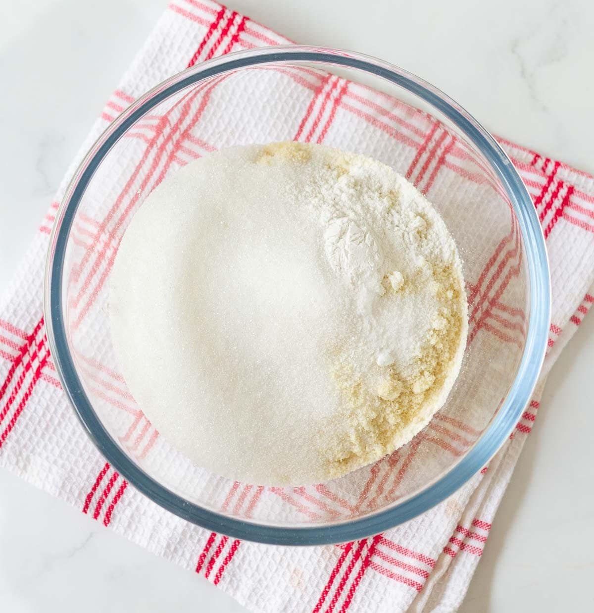 Dry ingredients for making cake in a mixing bowl.
