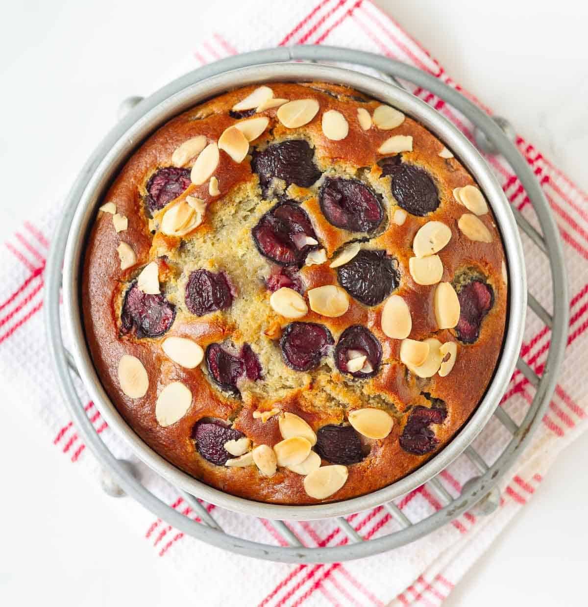 Baked cherry cake in a round cake pan.