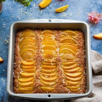 Eggless Coconut Peach Cake in a square baking pan.