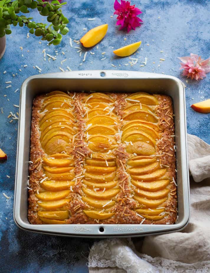 Eggless Coconut Peach Cake in a square baking pan.