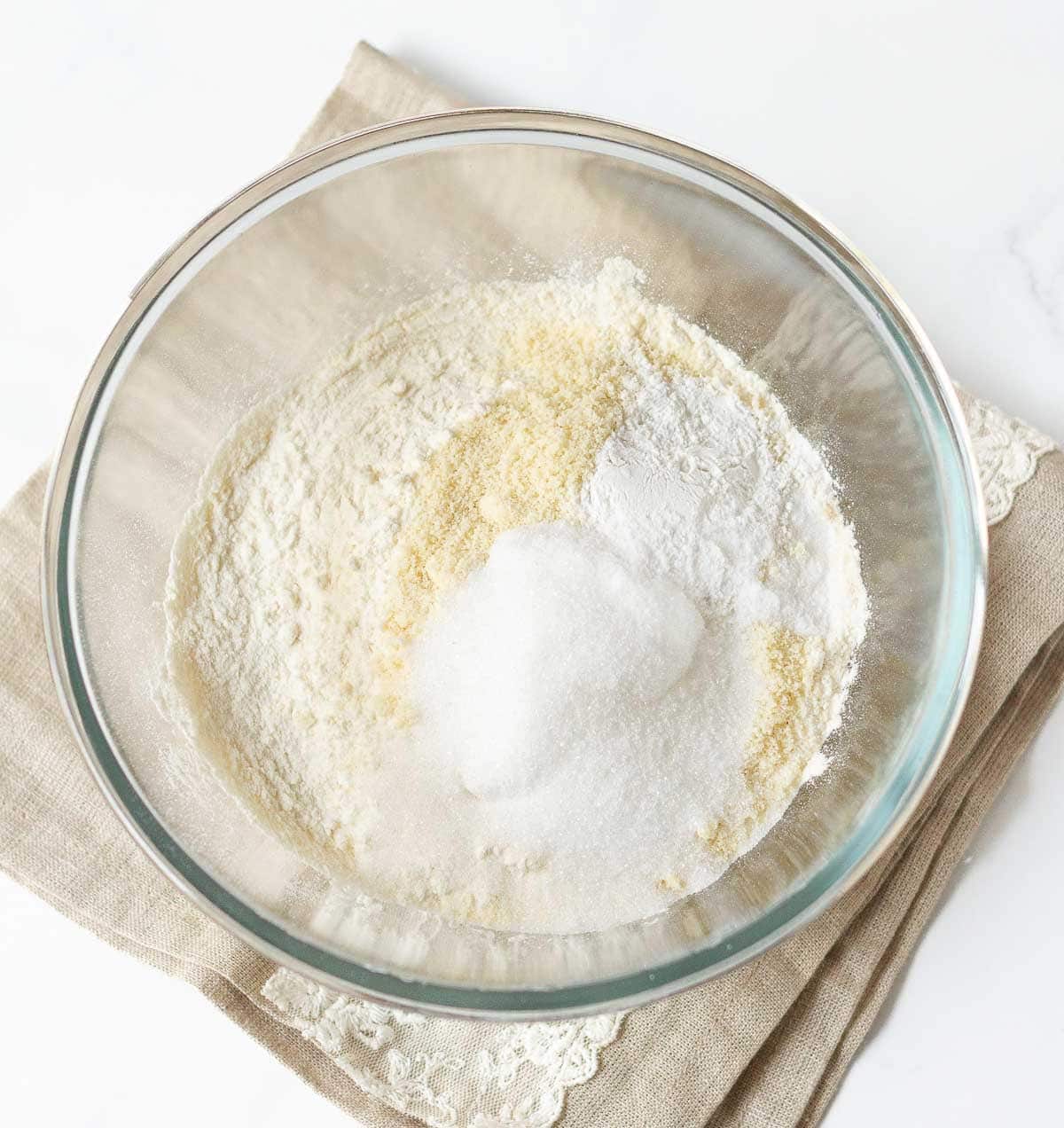 Flour, sugar, baking soda, baking powder, and salt in a mixing bowl.