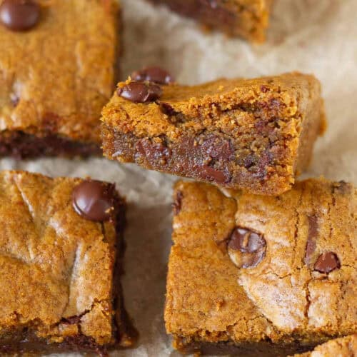A piece of blondie kept sideways to show the fudgy texture.