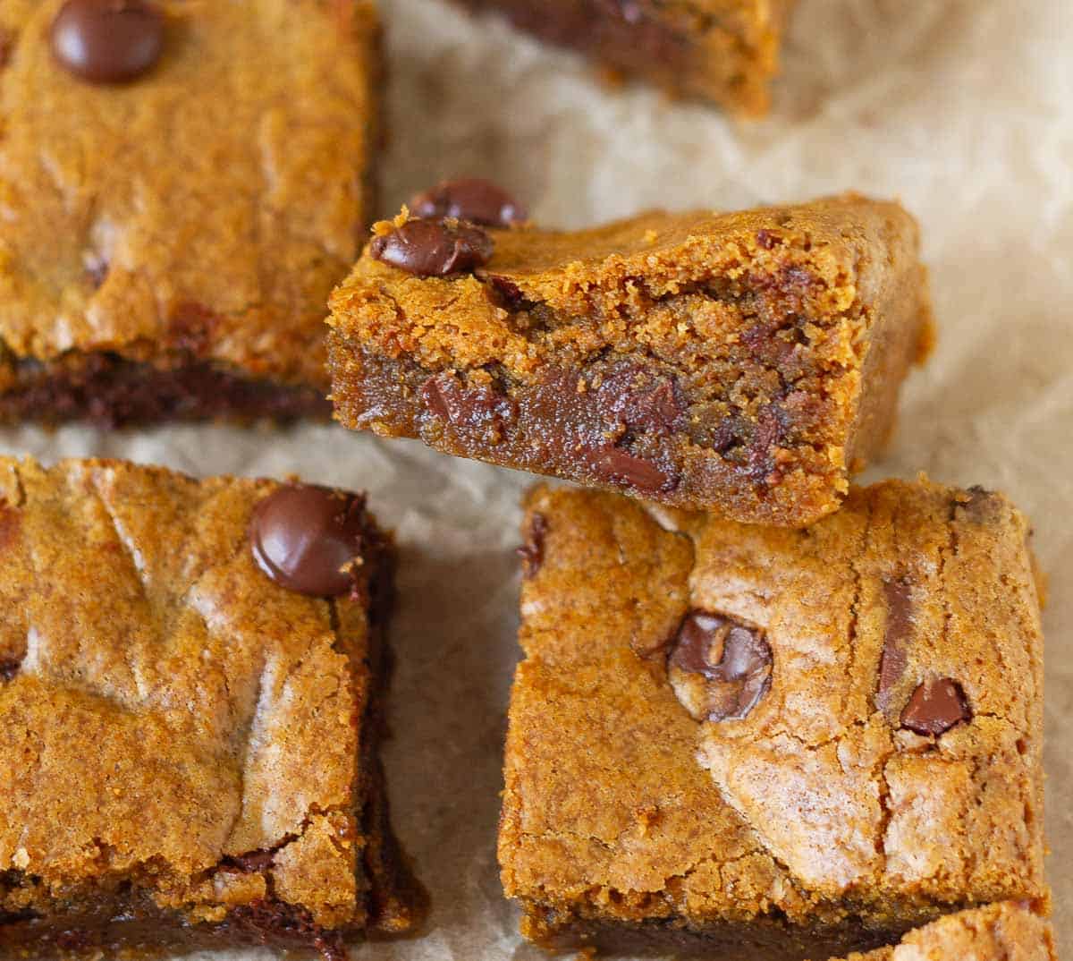 A piece of blondie kept sideways to show the fudgy texture.