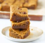 3 blondies stacked on a small plate.