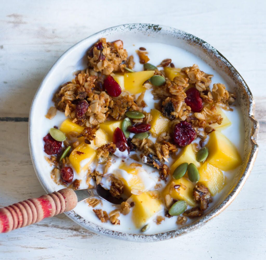 Crumbled Easy Homemade granola with yogurt and mango