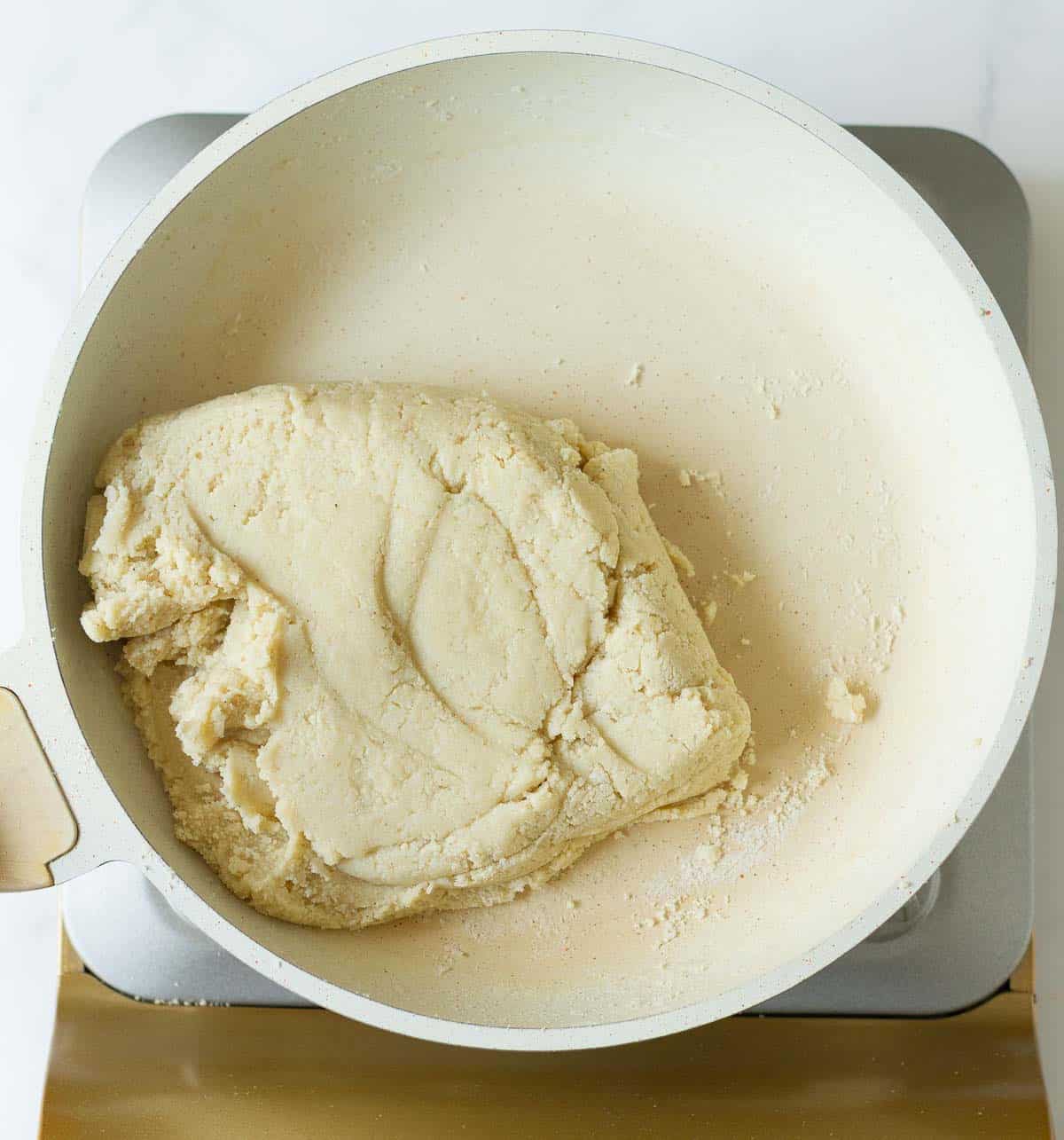 Cashew dough in a saucepan.