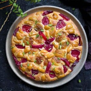 cake with plums and apricots on a platter.