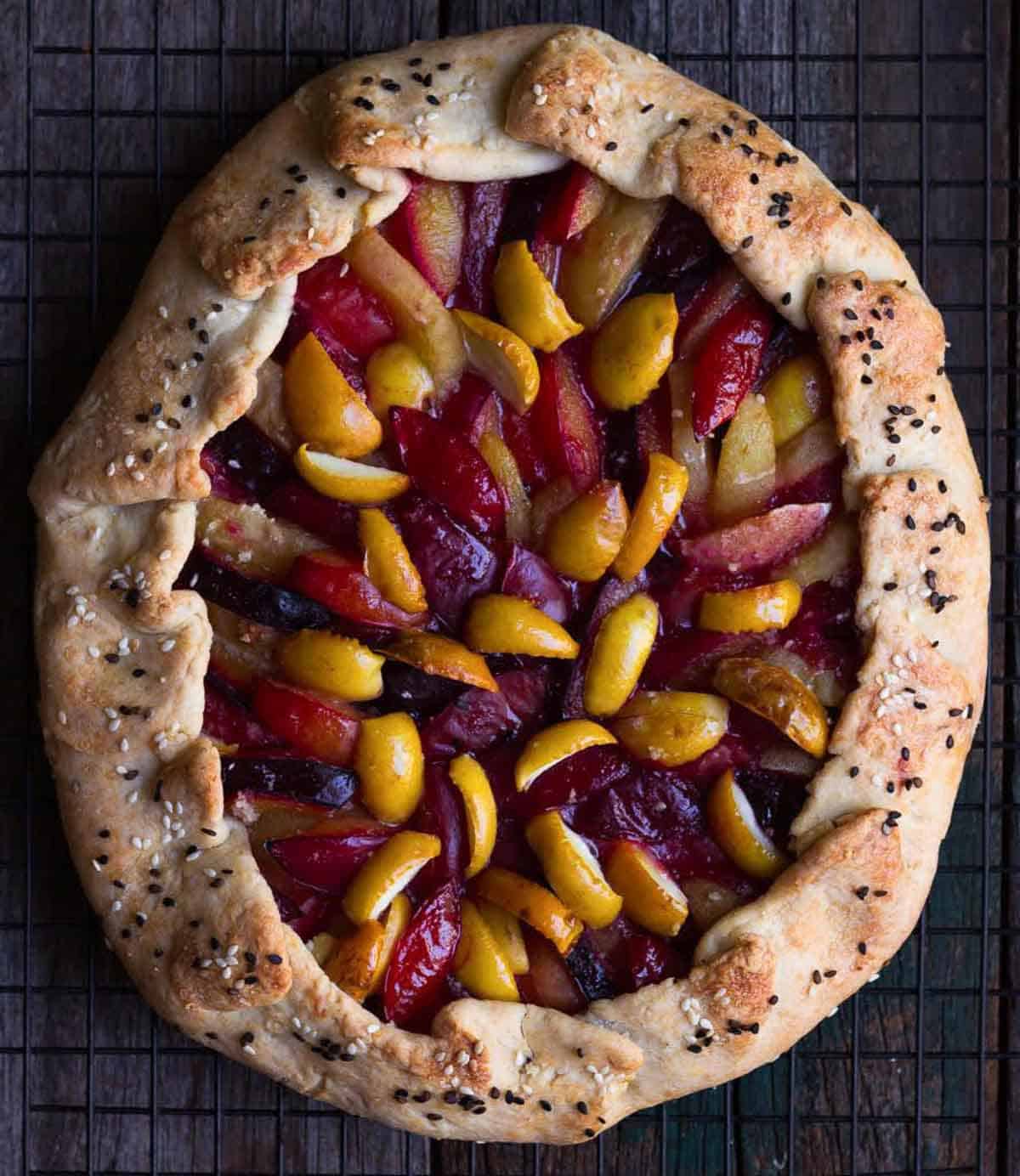 Baked fruit galette on a wire rack.