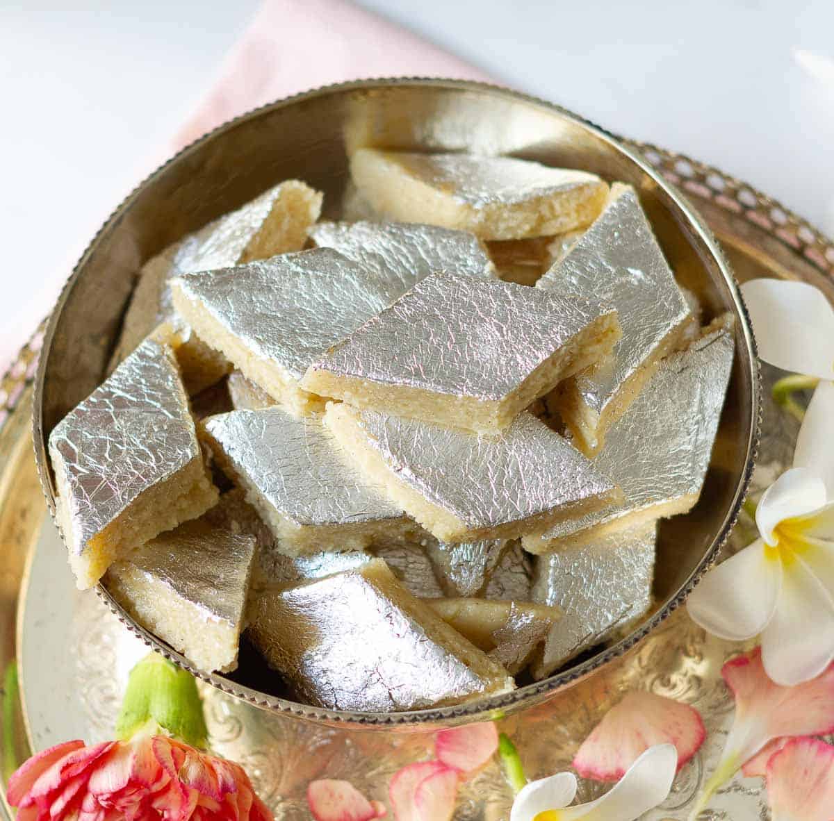 A silver bowl filled with cashew burfi.