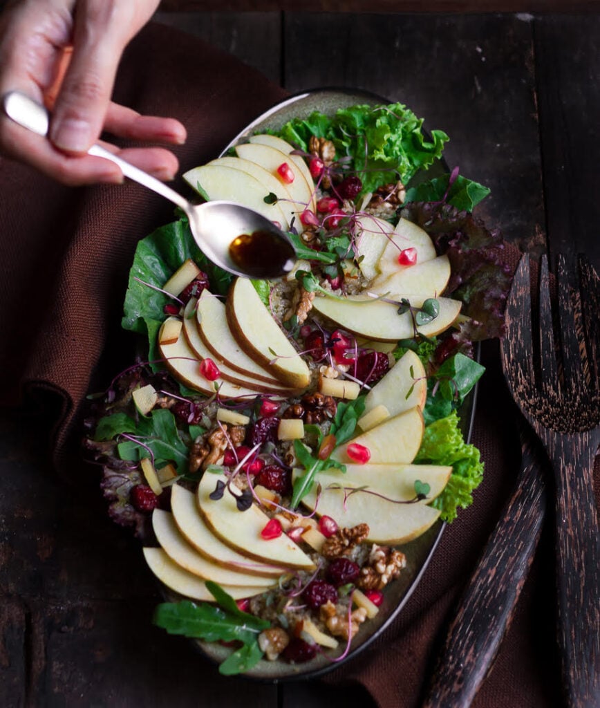 Pouring the balsamic vinaigrette over the Apple Walnut Salad | Easy healthy apple salad recipe