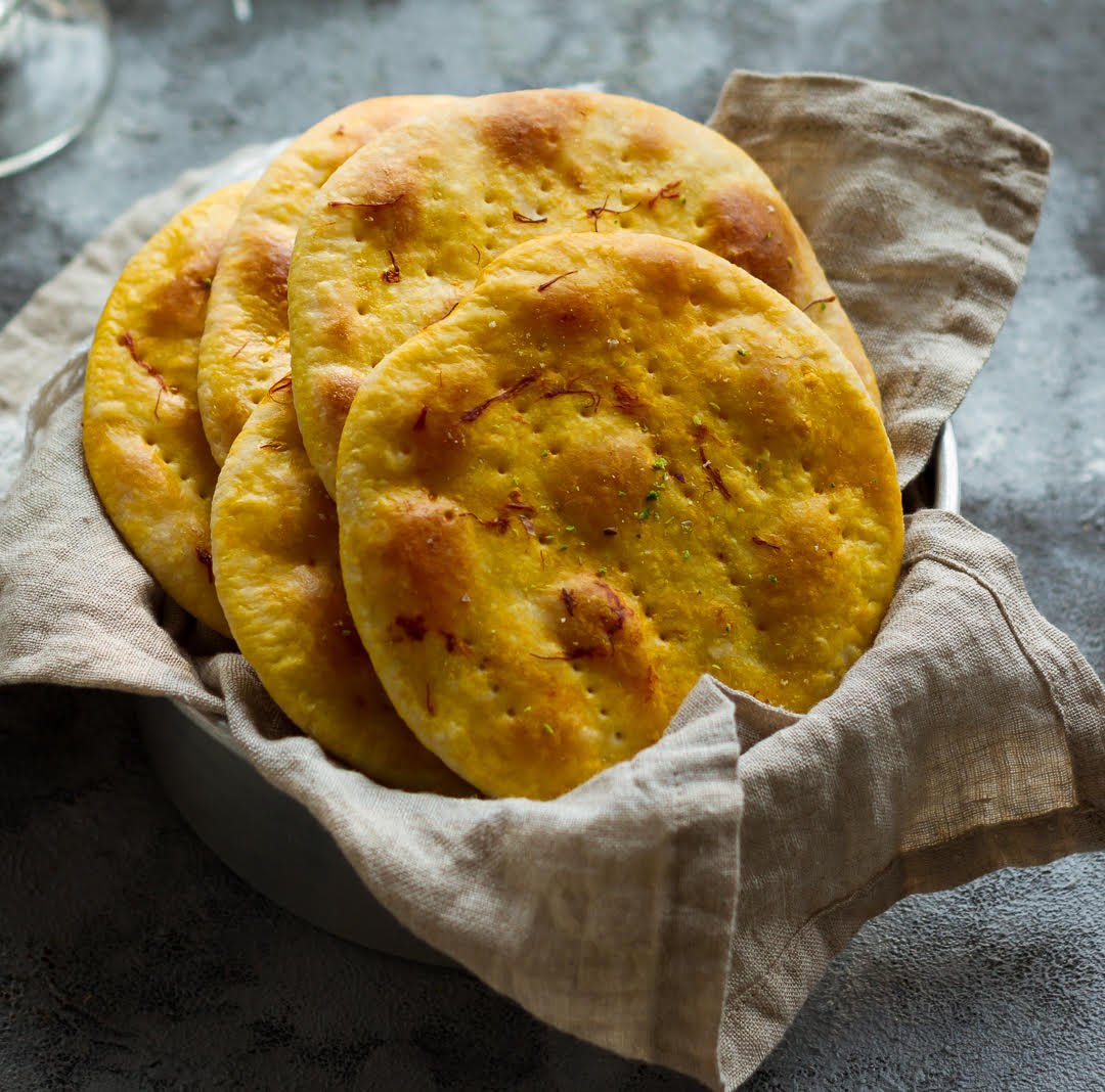 Sheermal breads in a napkin lined basket.