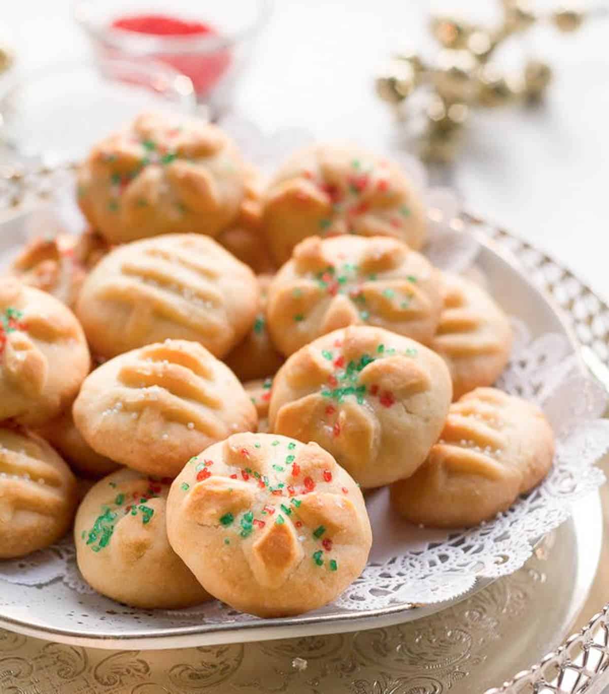 Butter cookies with red and green sprinkles on a tray.
