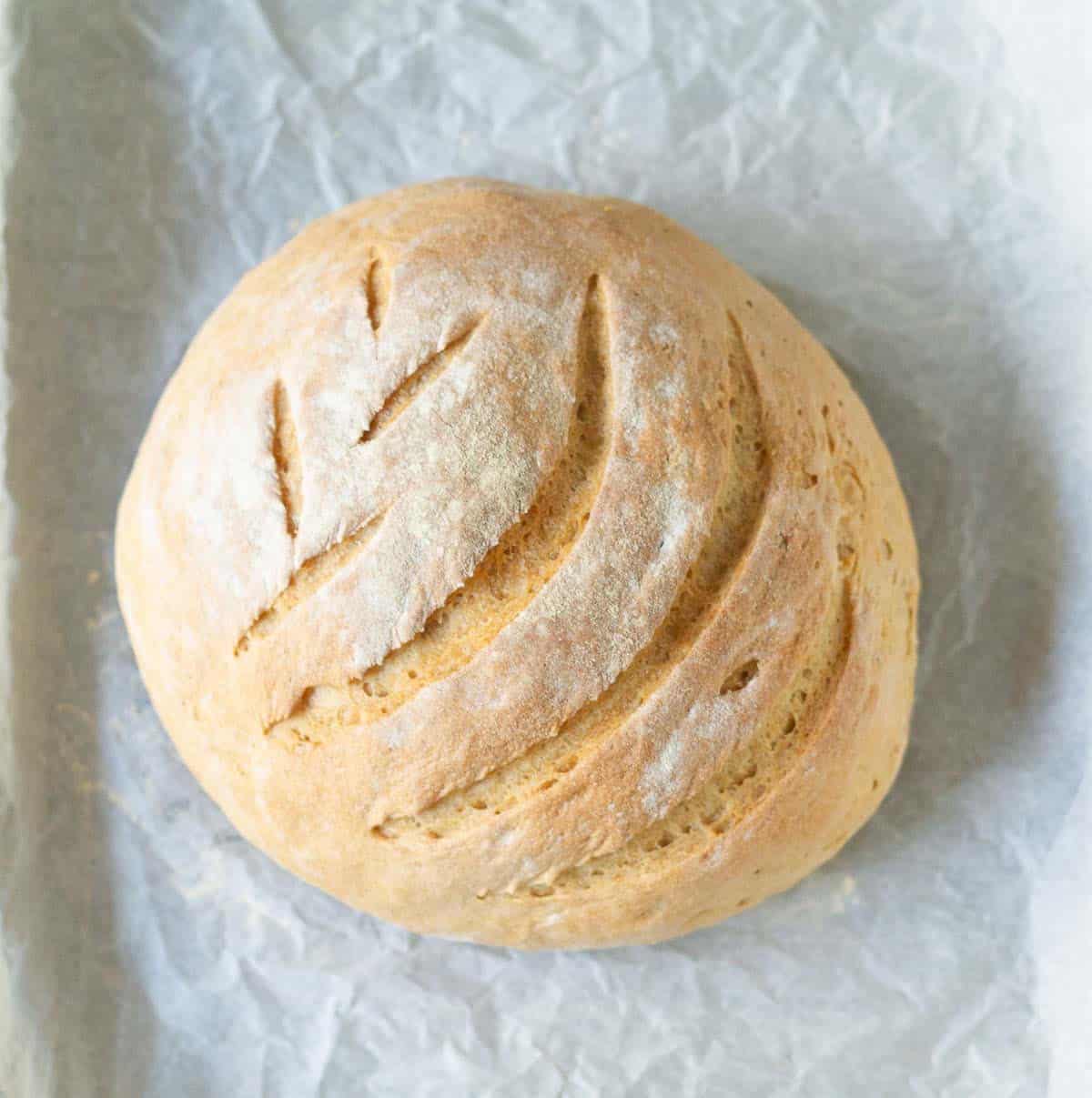 Baked sourdough discard bread on parchment paper.