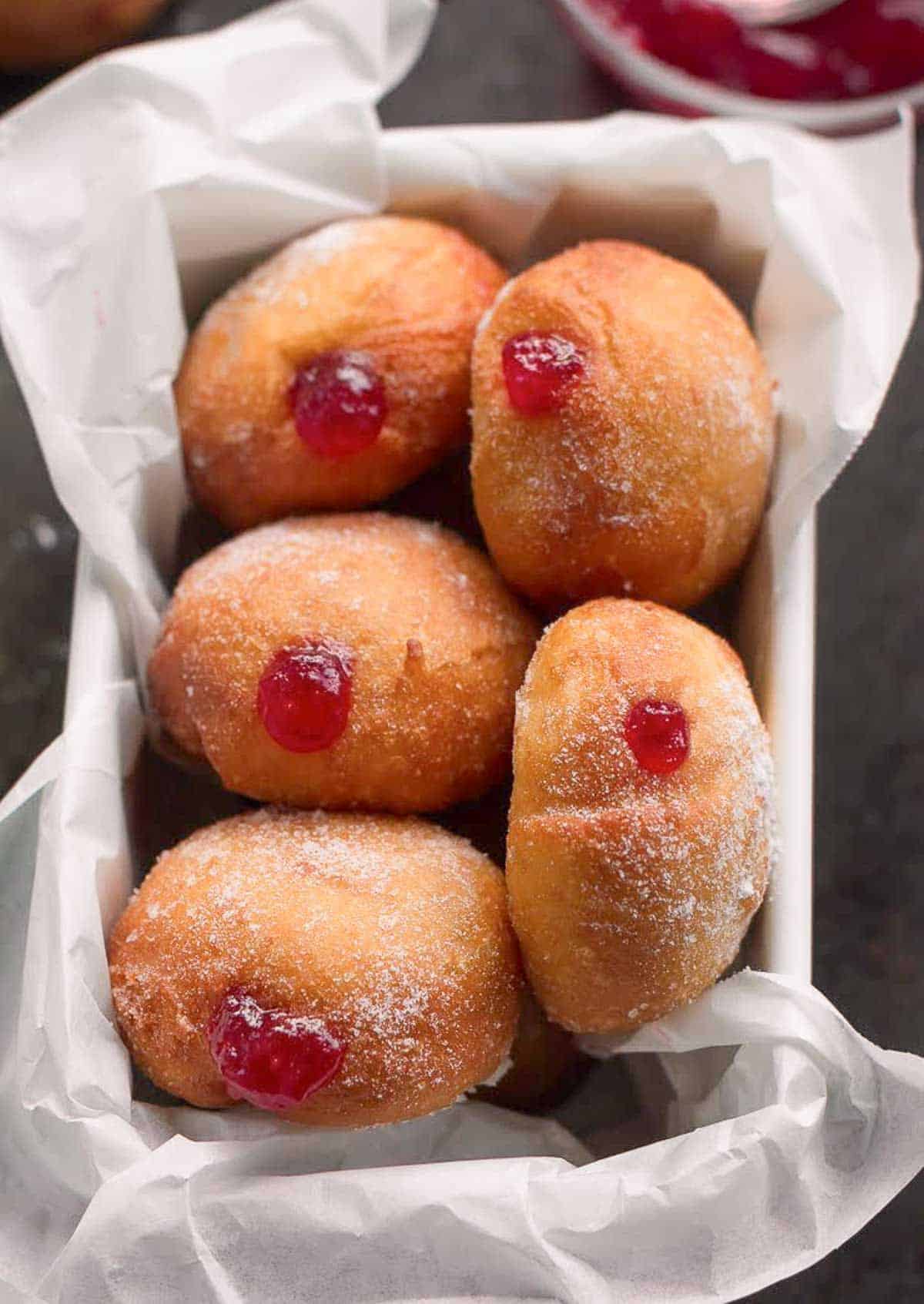 strawberry donuts in a paper lined loaf tin.