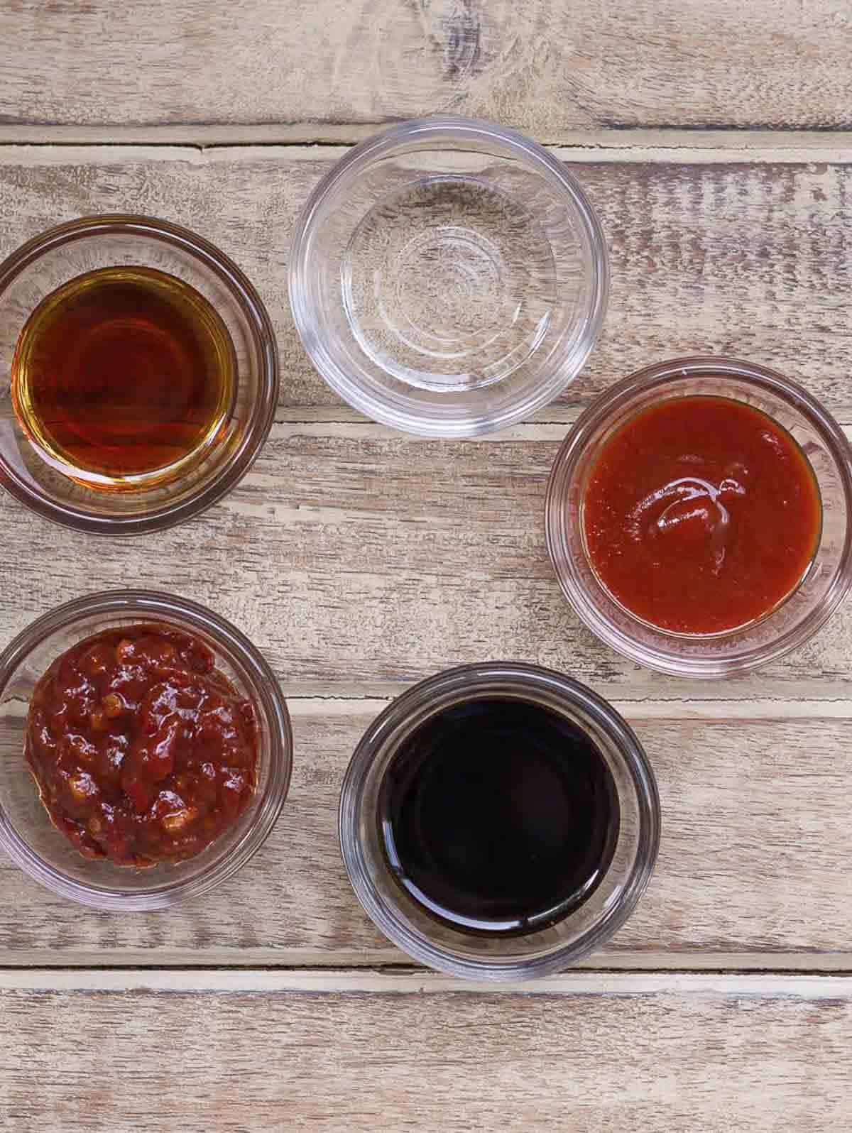 Ingredients for making sweet spicy sauce in small bowls.