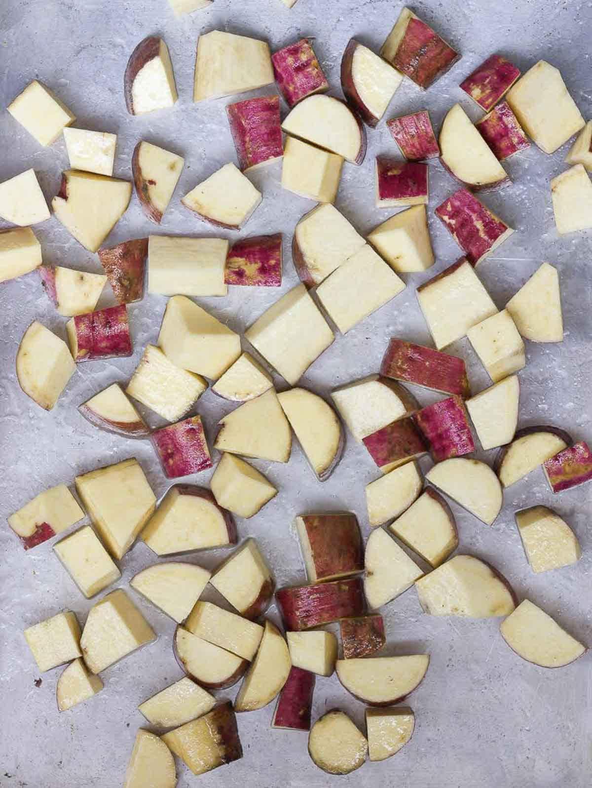 Diced sweet potatoes on a baking tray.