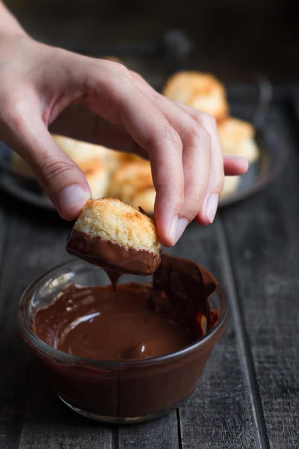 Dipping the coconut macaroons in dark chocolate