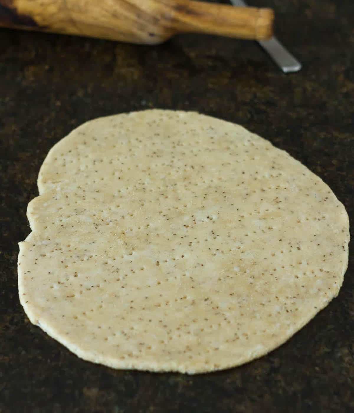 Rolled out dough with a rolling pin.