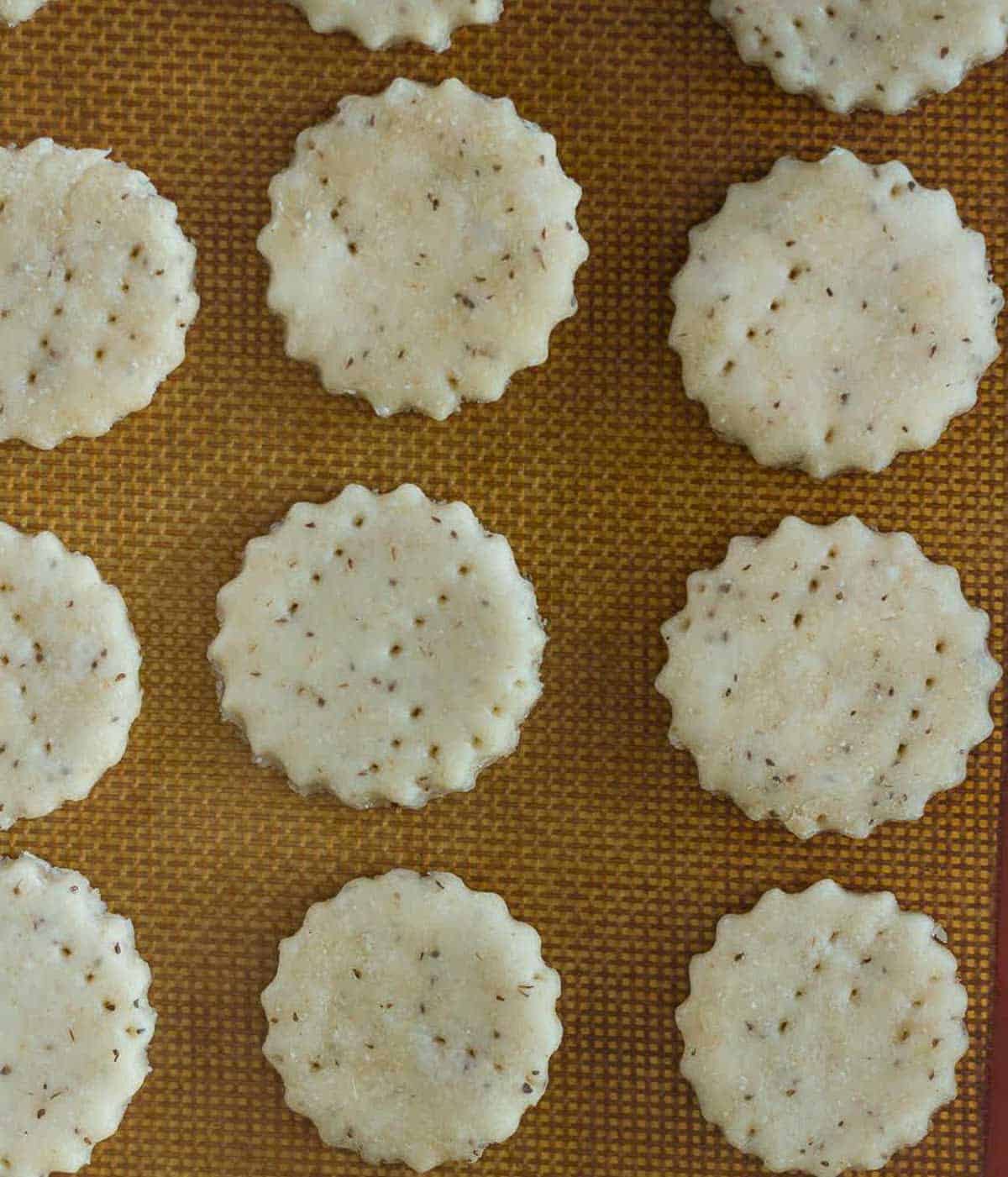 Cut outs of mathri dough on silpat sheet.
