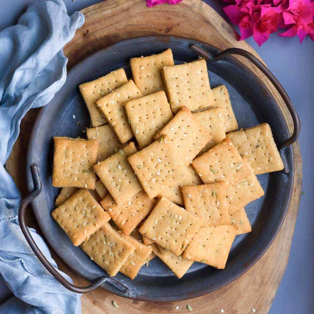 A stack of sweet mathri on a grey plate.