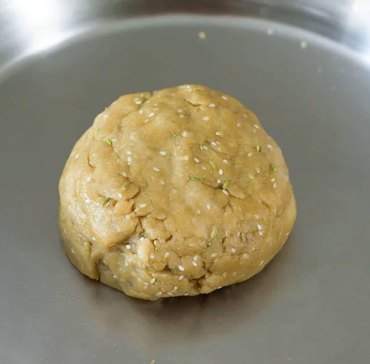 dough in a stainless steel bowl.