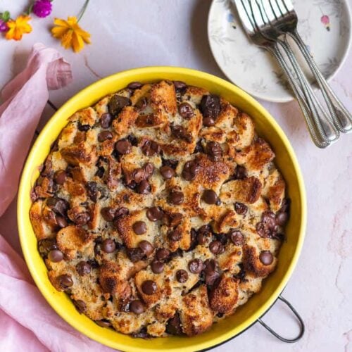 Chocolate Chip Bread Pudding in a yellow round dish with forks on the side.