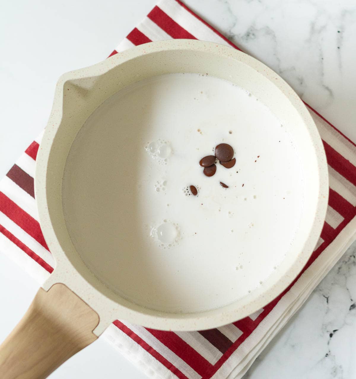 Milk and chocolate in a saucepan.